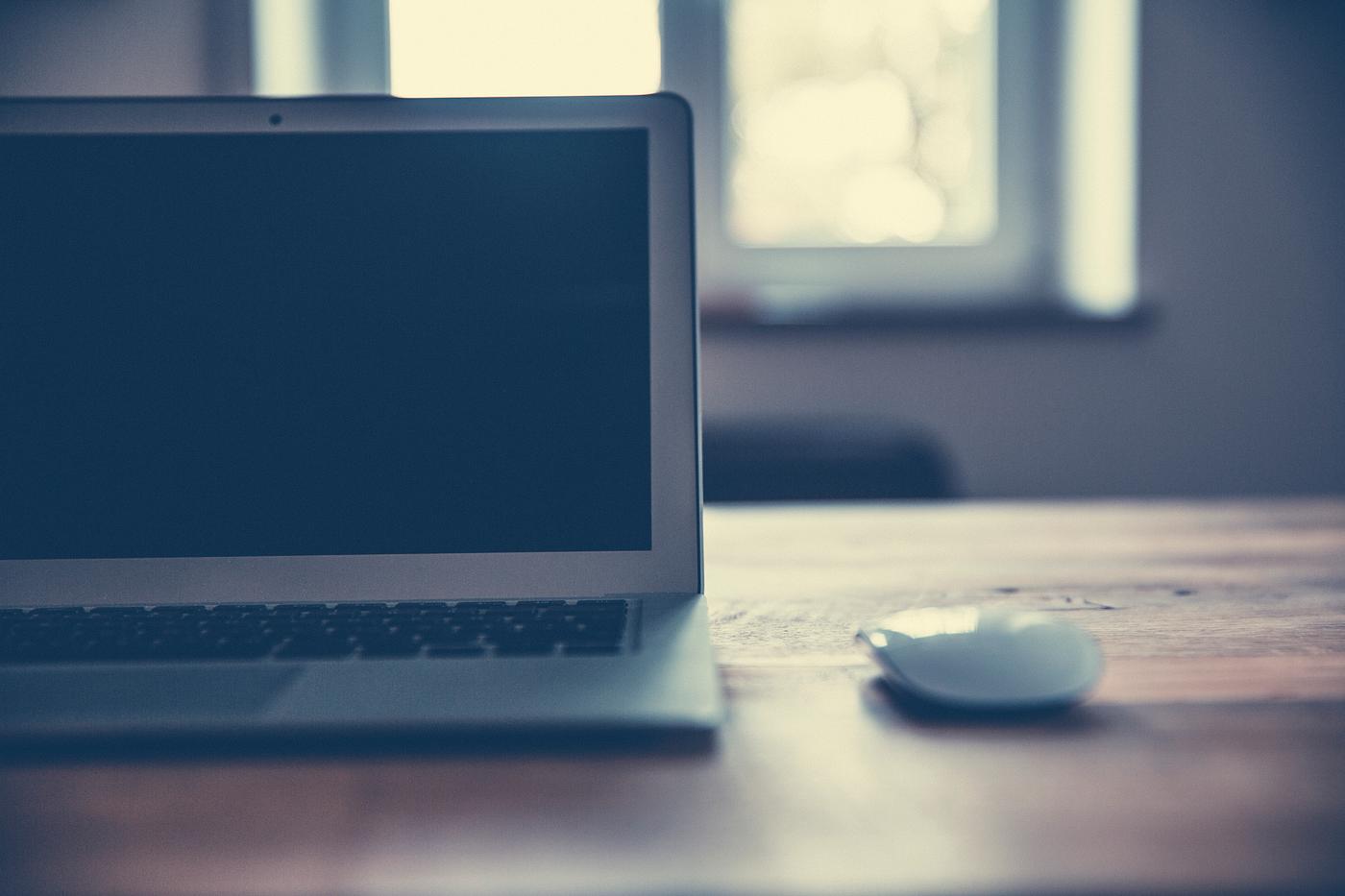 Laptop on a wooden desk Laptop on a wooden desk