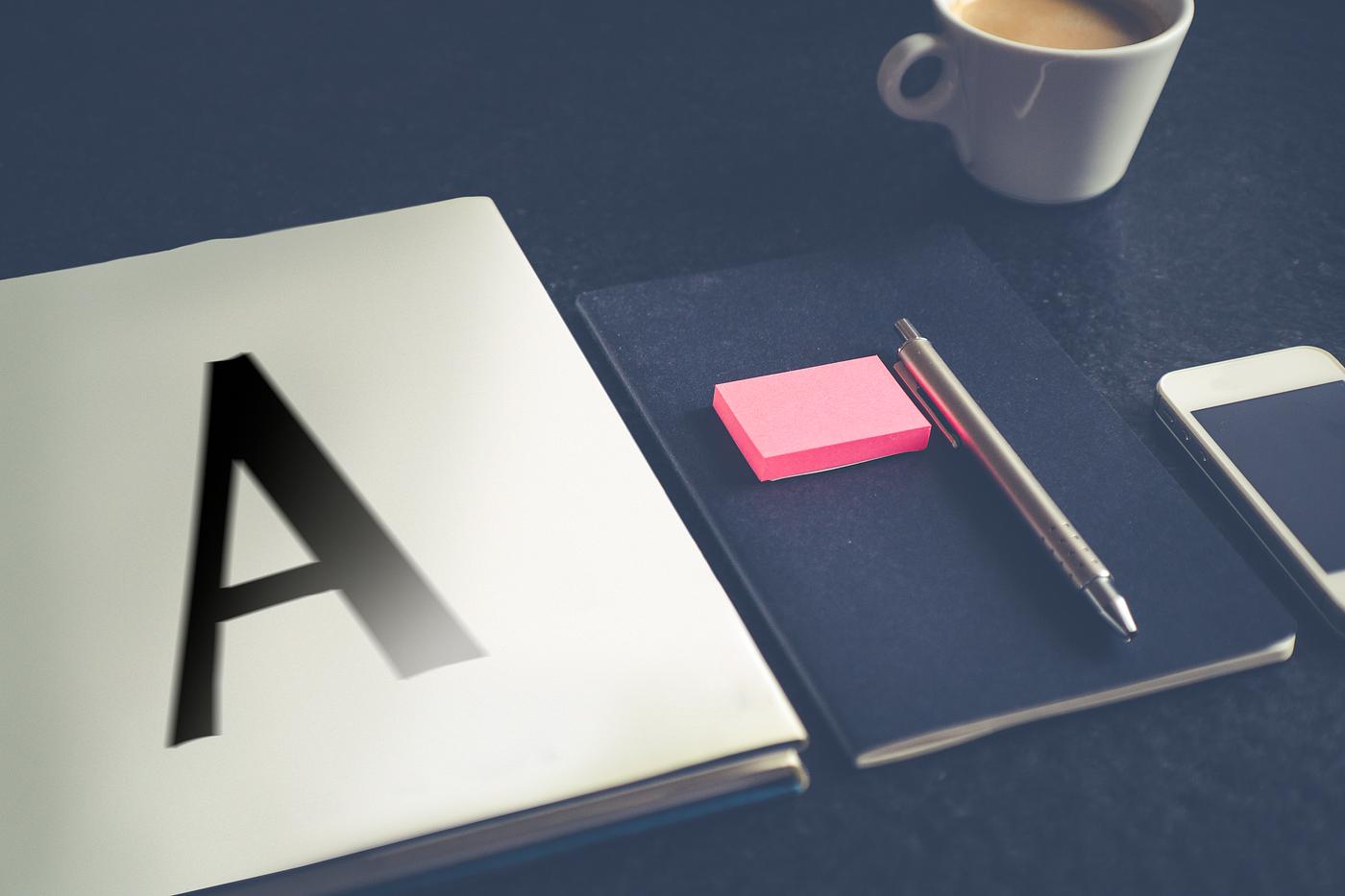 A notebook with letter a on a dark table A notebook with letter a on a dark table