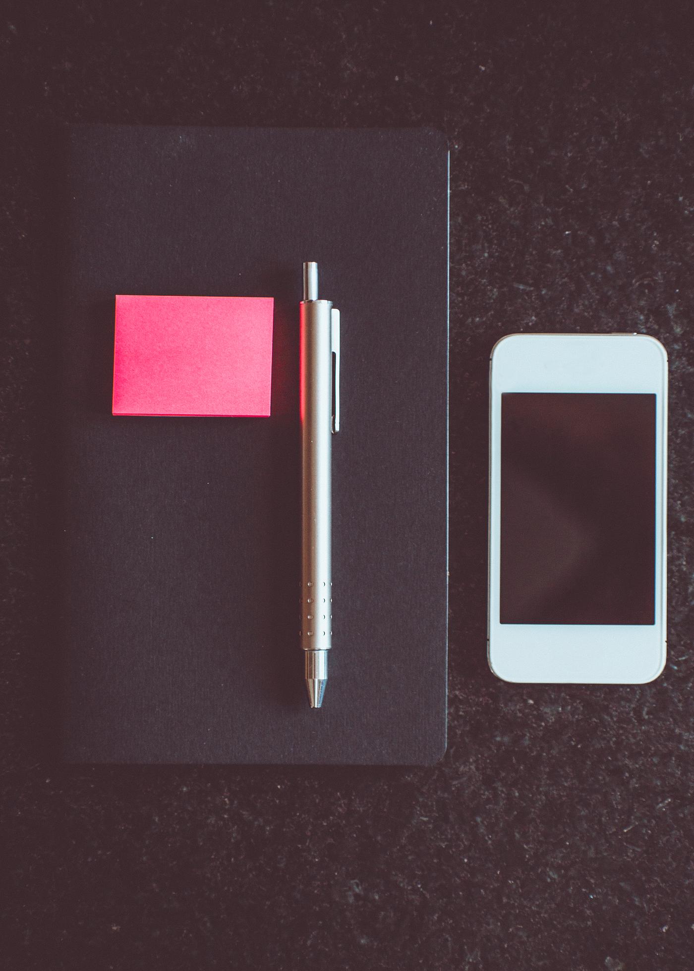 Notebook and phone on a table Notebook and phone on a table