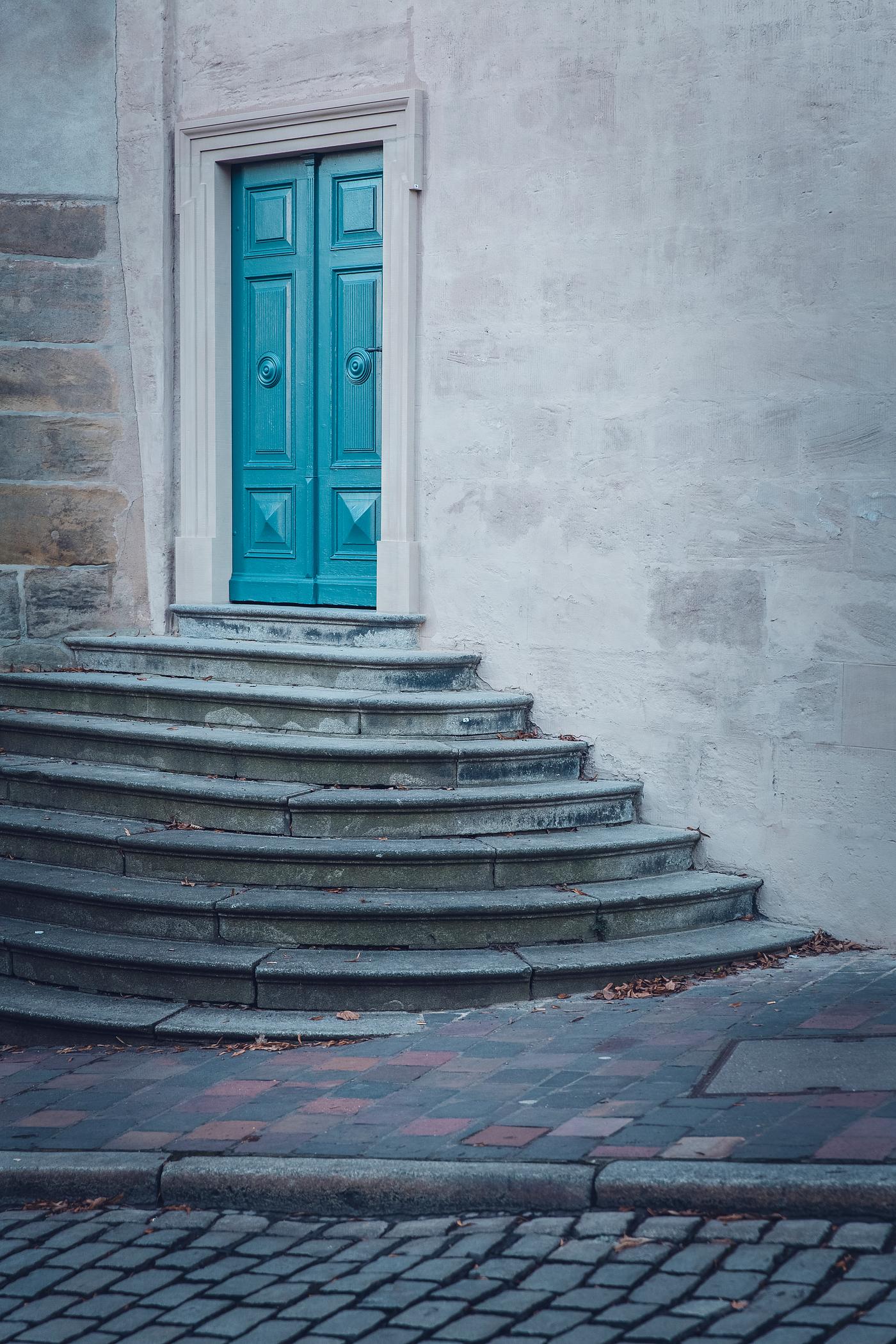 Blue door atop a small staircase Blue door atop a small staircase