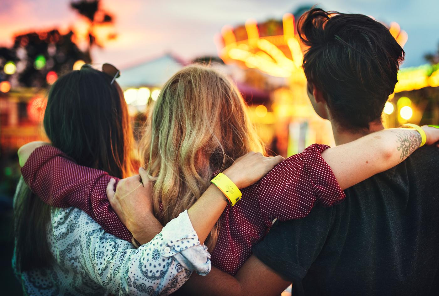 A group of friends is enjoying the amusement park A group of friends is enjoying the amusement park