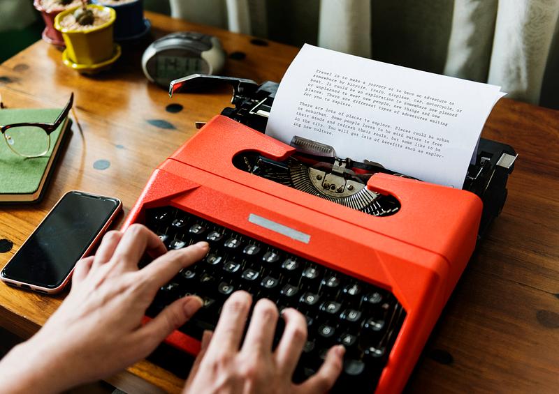 Woman typing vintage typewriter on wooden tab Royalty free stock Woman typing vintage typewriter on wooden tab Royalty free stock