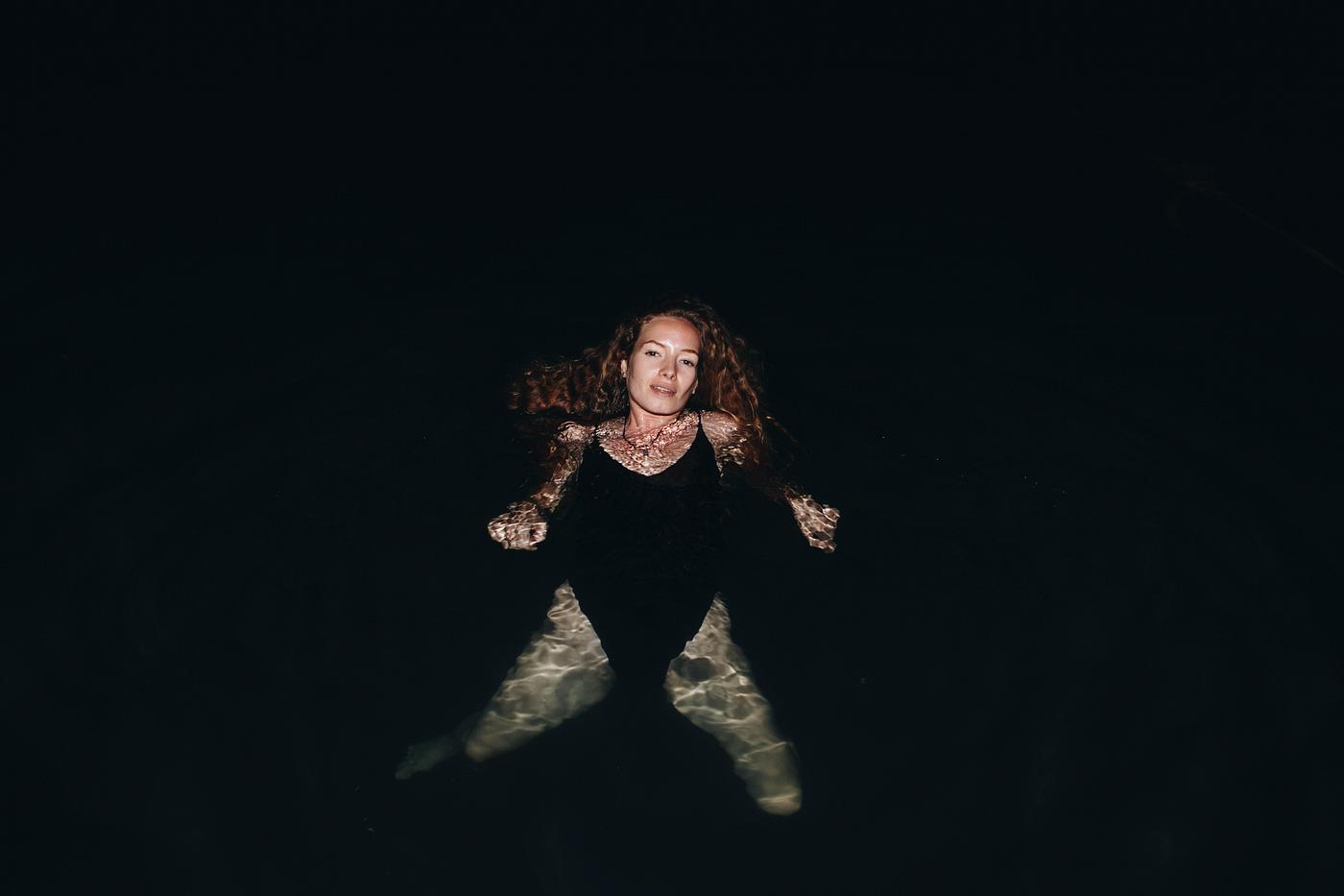 Woman swimming in the dark - alone, bathing, bathing suit, black, caucasian, dark, darkness, deep, enjoying, enjoyment,... Woman swimming in the dark - alone, bathing, bathing suit, black, caucasian, dark, darkness, deep, enjoying, enjoyment,...