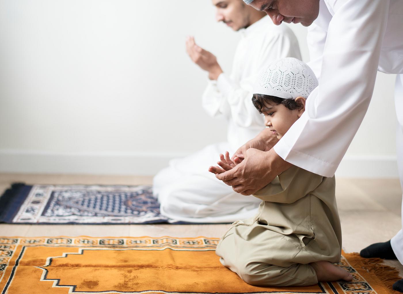  Muslim  boy learning how to make Dua  to Allah Royalty 
