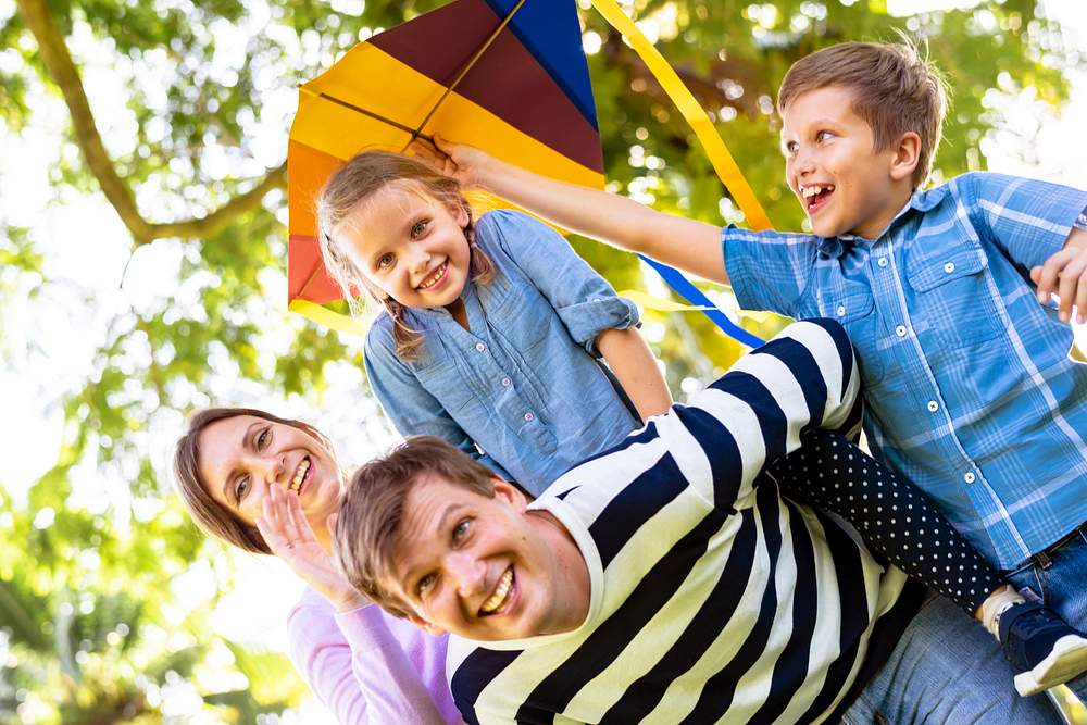Family playing with a colorful kite