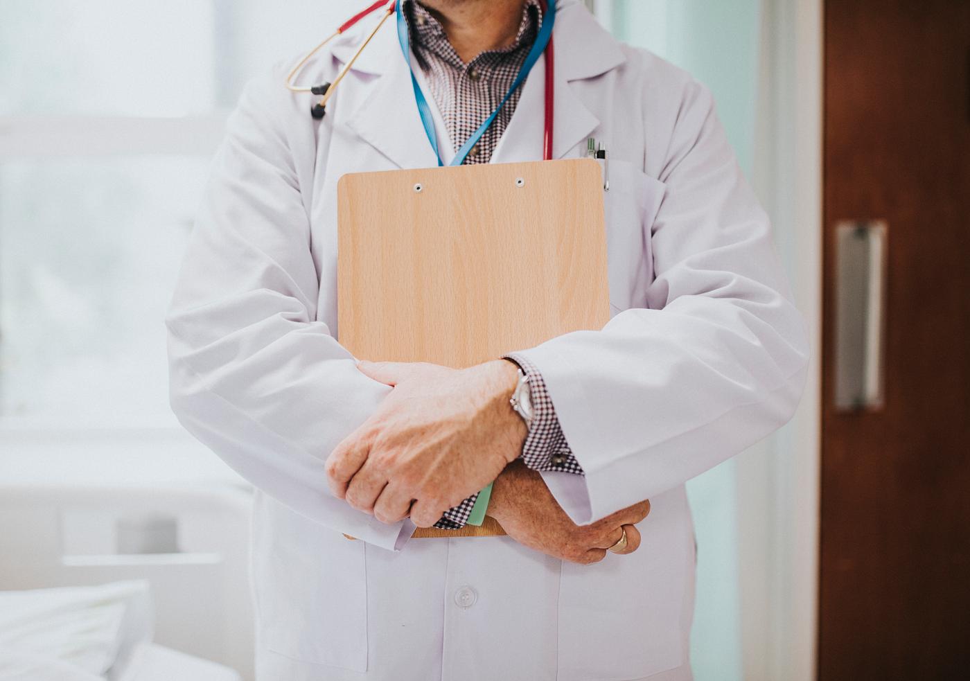 Physician holding a clipboard with medical information
