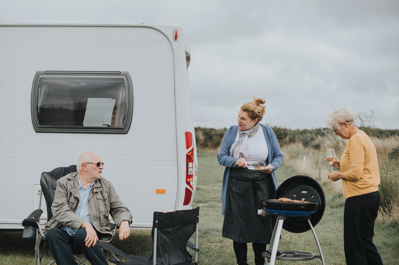 Elderly woman grilling delicious bbq meat - barbeque, bbq, bonding, british, camp site, campers, camping, camping site,... Elderly woman grilling delicious bbq meat - barbeque, bbq, bonding, british, camp site, campers, camping, camping site,...