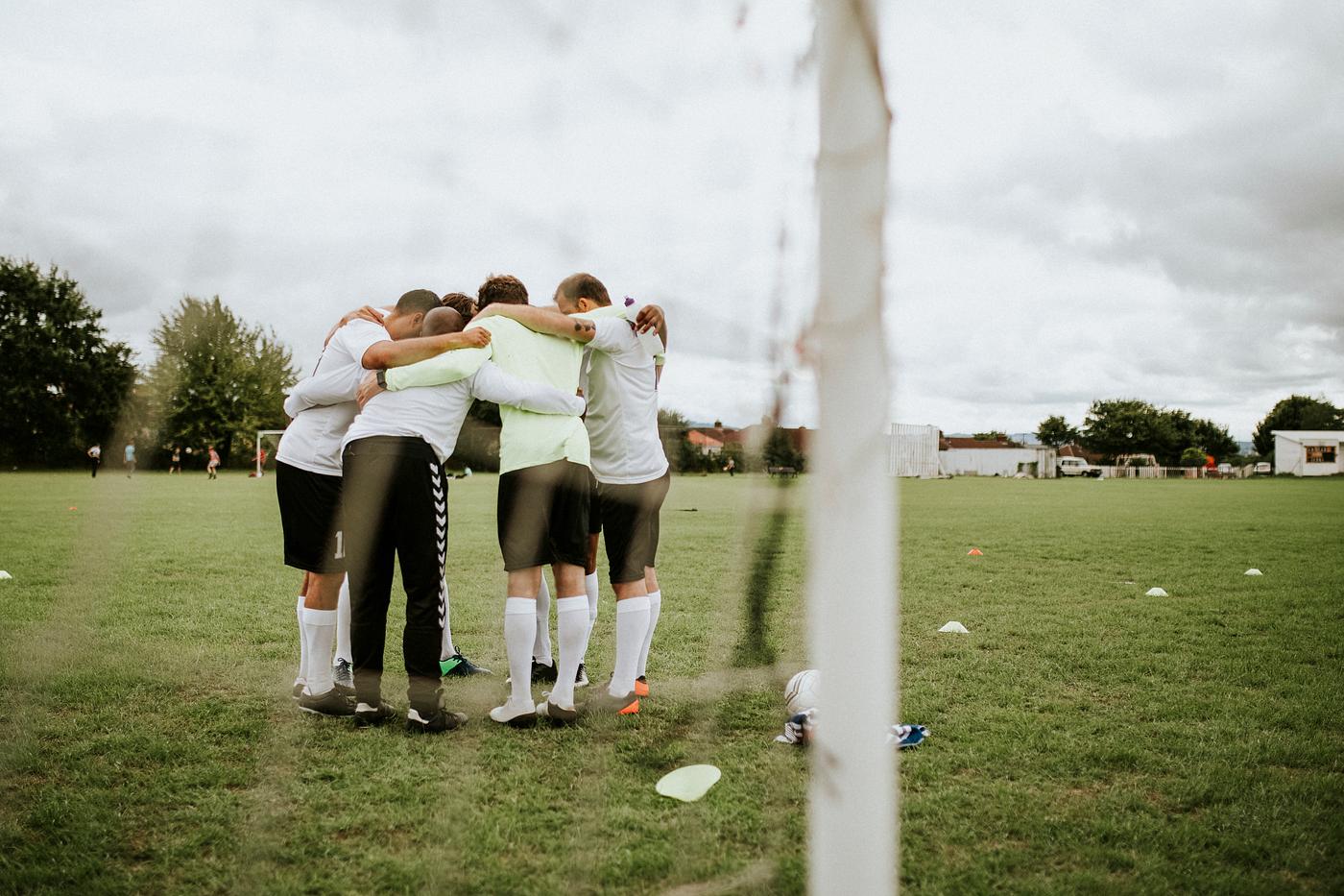 Young soccer players discussing strategy on soccer field