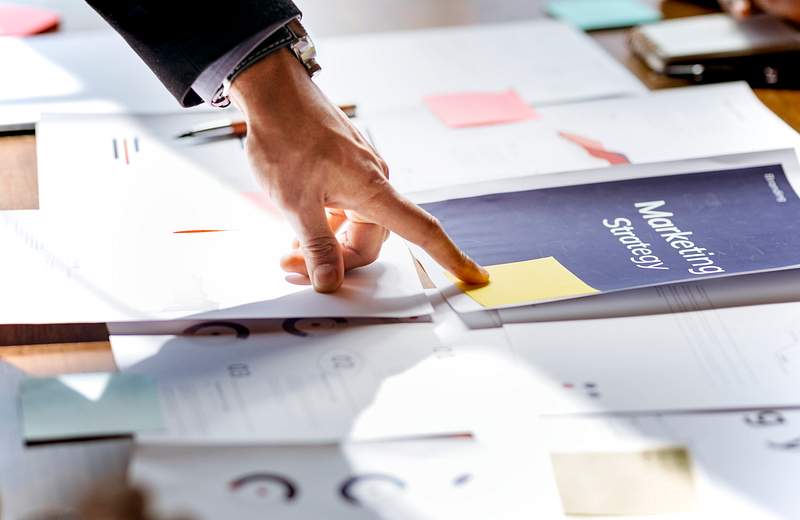 How To Discover Content Ideas For Restaurant Social Media Marketing 2 Hand pointing on a marketing strategy document