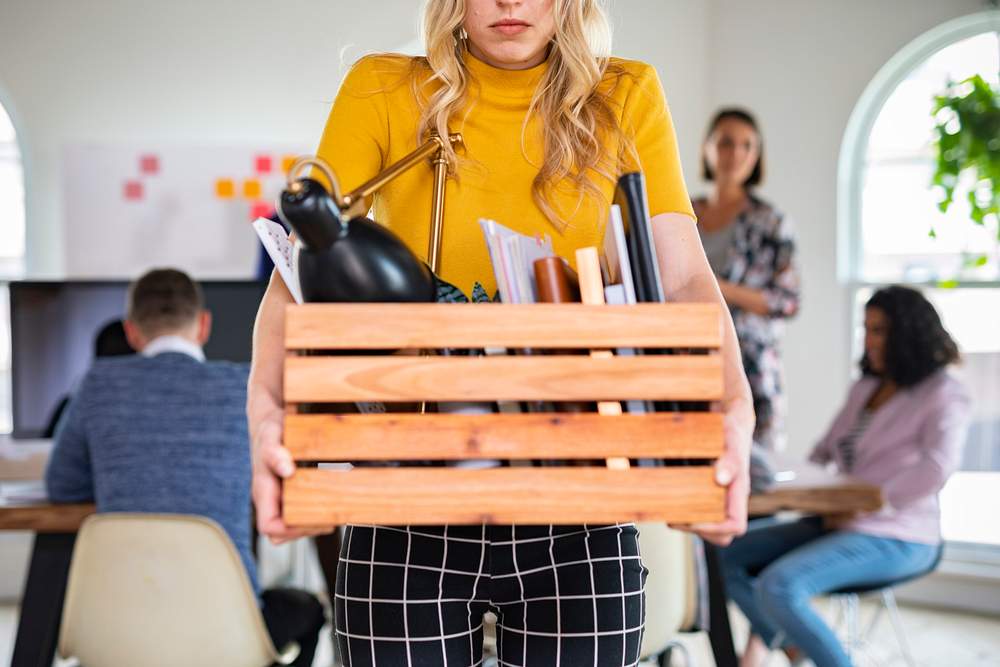 Young businesswoman carrying a wooden box