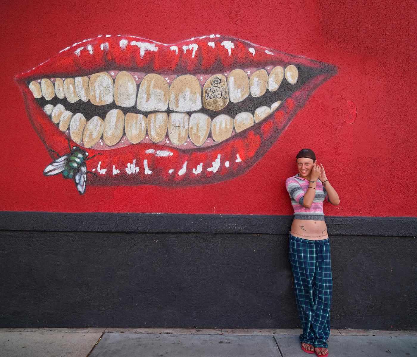 Courtney Ashby adjusts an earring near a memorable mural on historic Fourth Avenue, now home to many trendy restaurants and... Courtney Ashby adjusts an earring near a memorable mural on historic Fourth Avenue, now home to many trendy restaurants and...