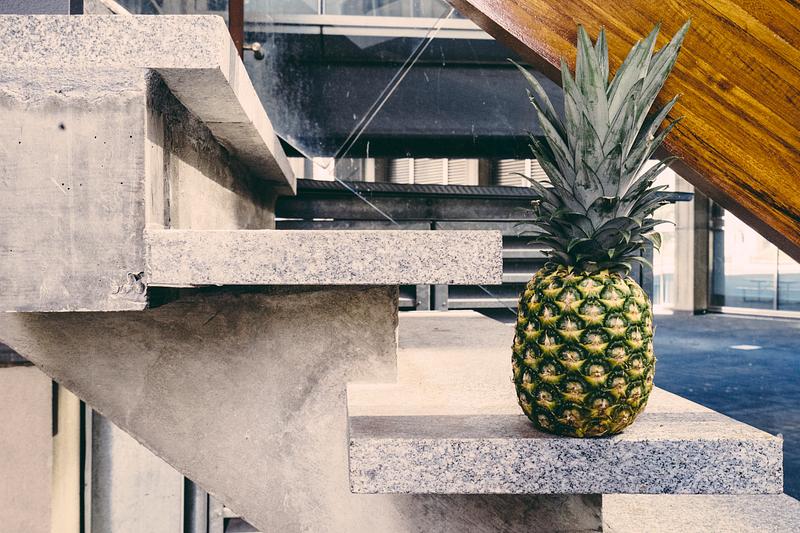 Tropical pineapple on concrete stairs Tropical pineapple on concrete stairs