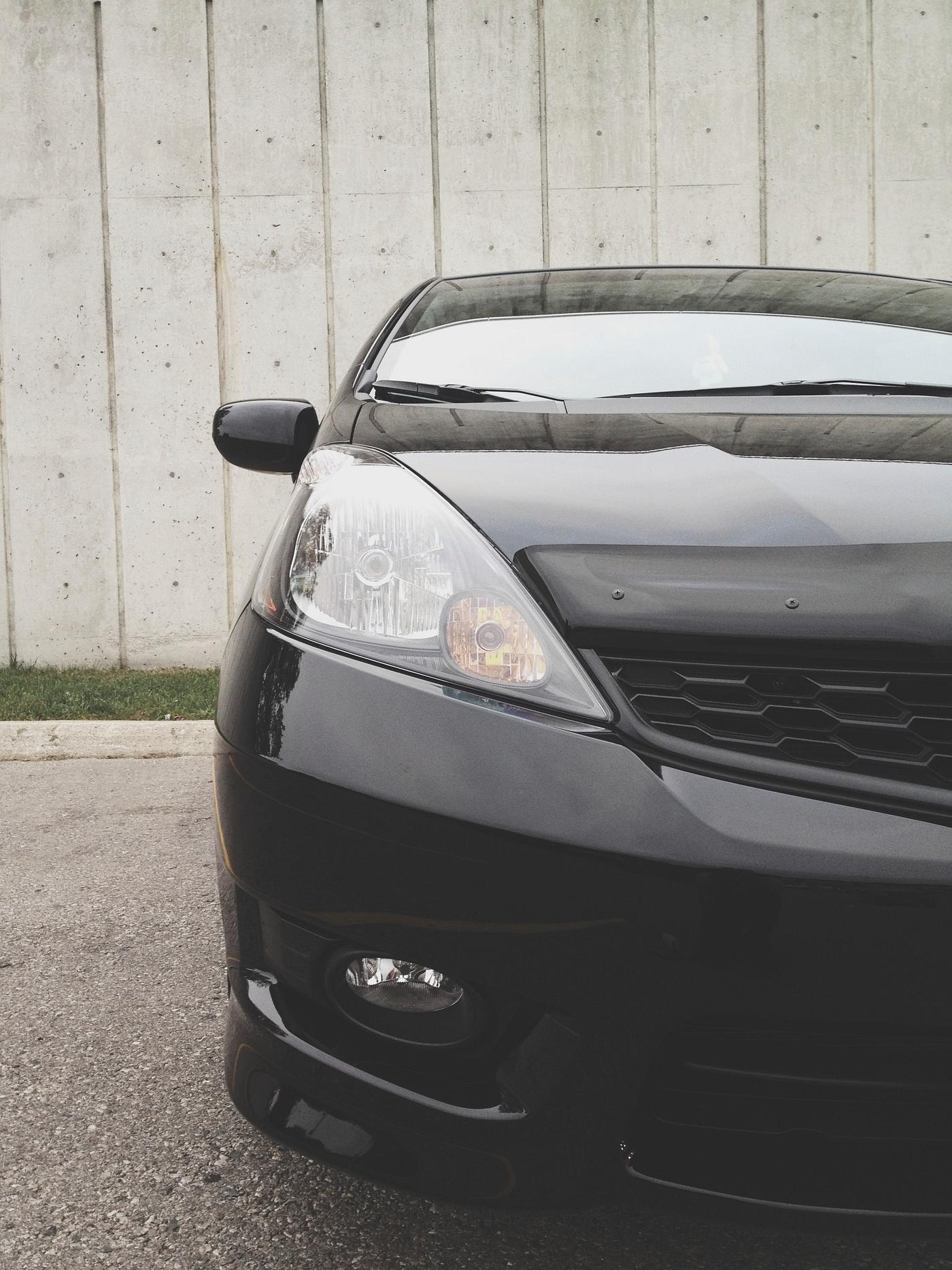 Front of a shiny black car Front of a shiny black car