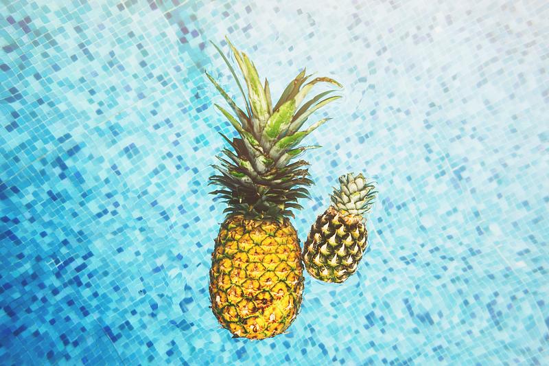 Tropical pineapples in a swimming pool Tropical pineapples in a swimming pool