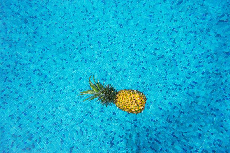 Tropical pineapple in a swimming pool Tropical pineapple in a swimming pool