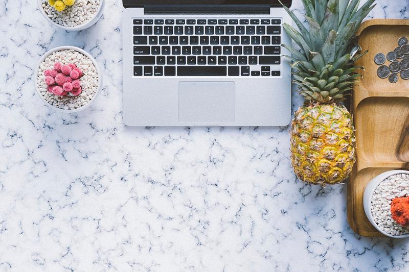 Pineapple next to a laptop Pineapple next to a laptop
