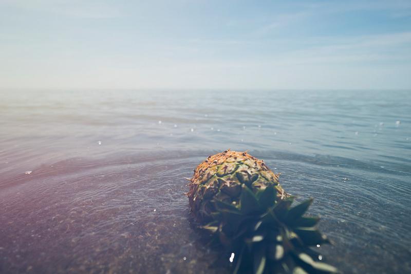 Pineapple lying in the sea water Pineapple lying in the sea water