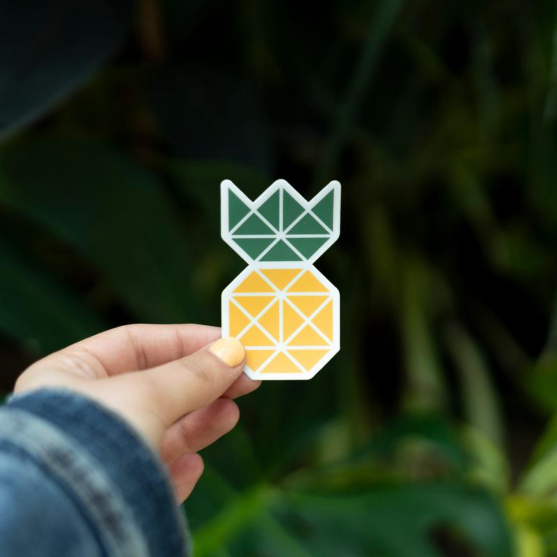 Pineapple sticker held up outdoors Pineapple sticker held up outdoors
