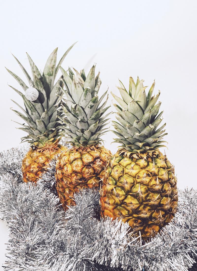 Ripe festive pineapple with silver garland Ripe festive pineapple with silver garland