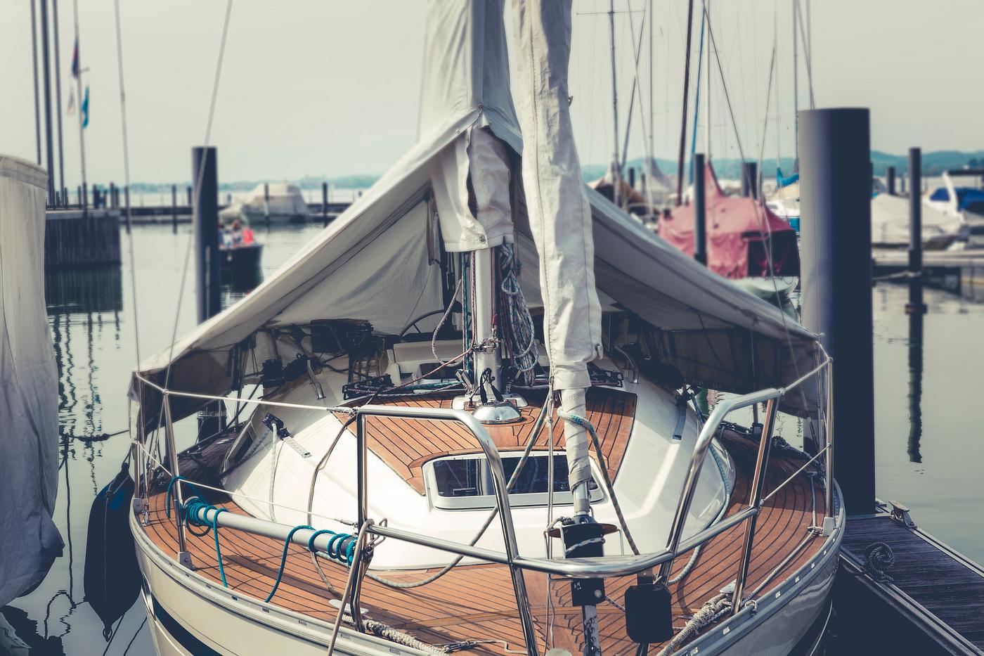 A luxury sailboat at a dock A luxury sailboat at a dock