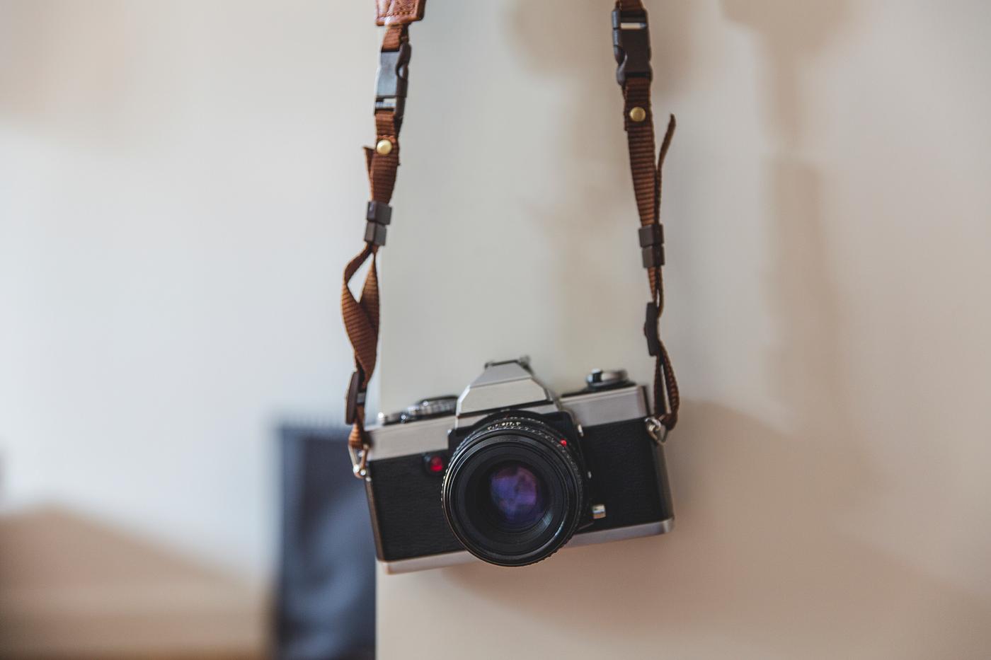 Vintage analog 35mm film camera hanging on a wall Vintage analog 35mm film camera hanging on a wall