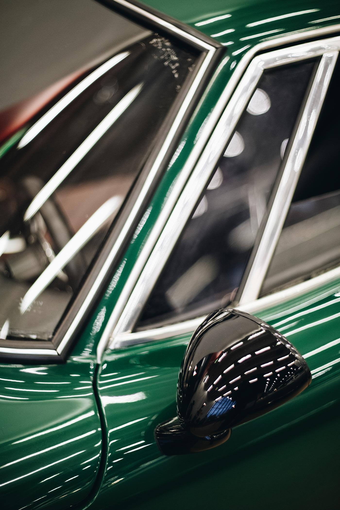 Close up of a green car mirror Close up of a green car mirror