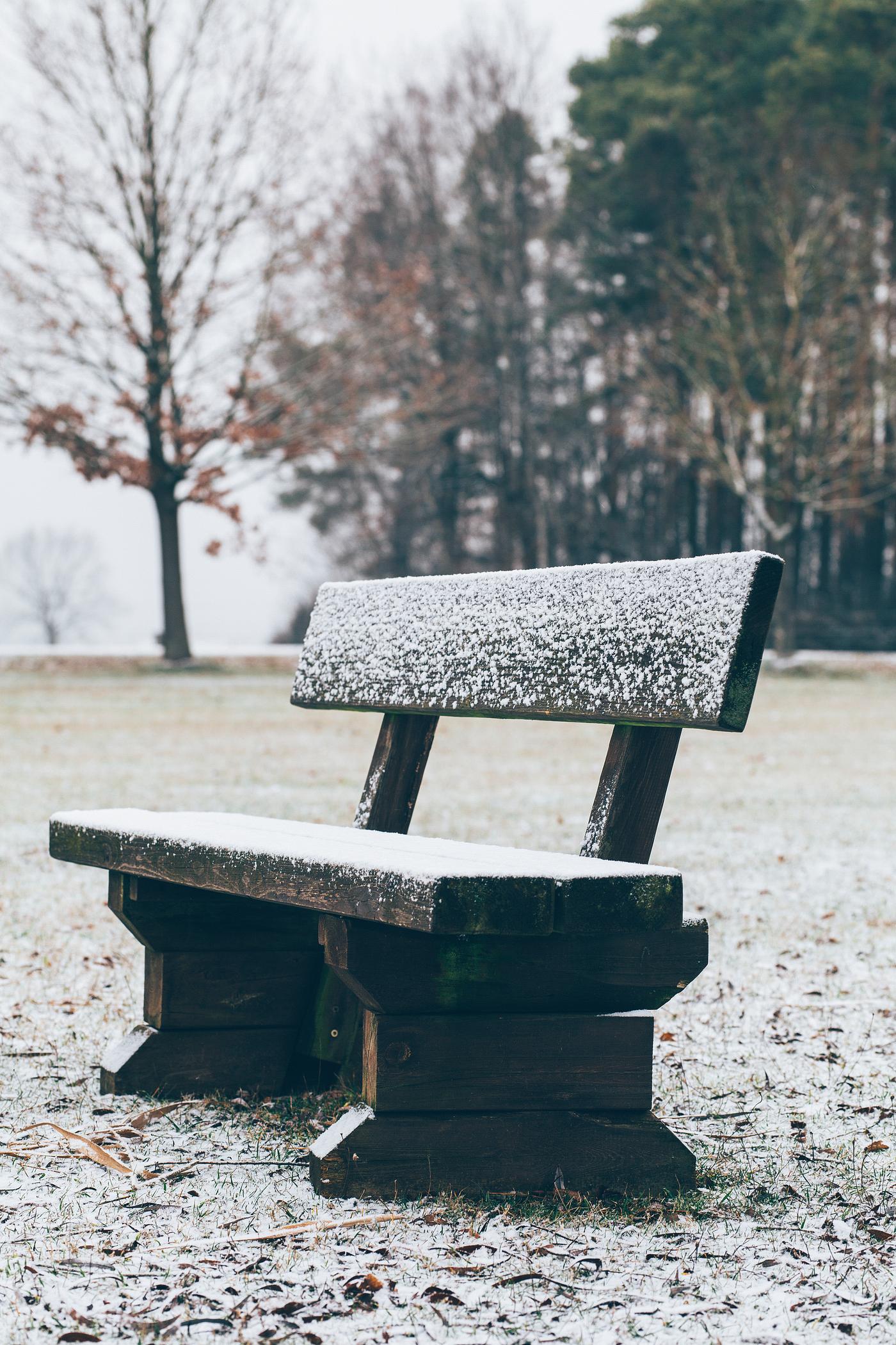 Wooden bench covered in snow Wooden bench covered in snow