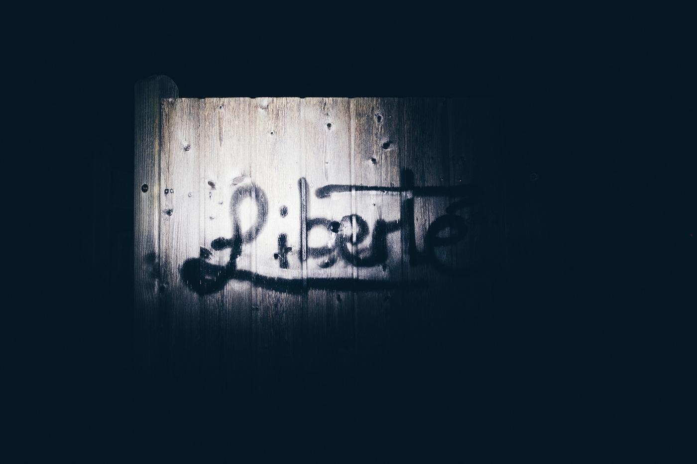 Liberte graffiti on a wooden texture Liberte graffiti on a wooden texture