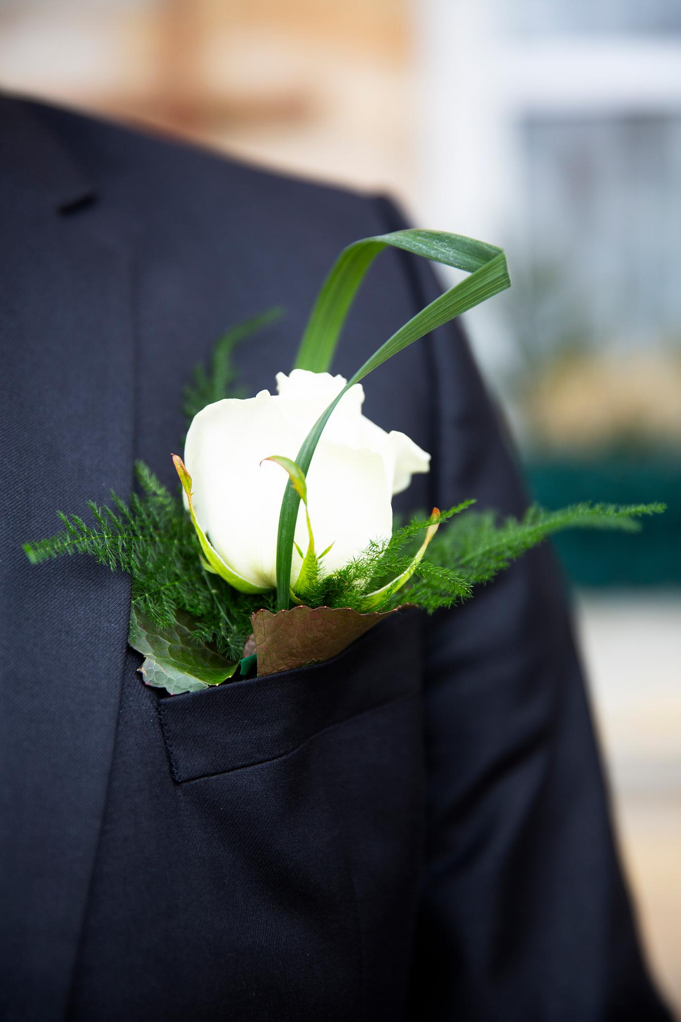 Groom wearing a boutonniere on his wedding day Groom wearing a boutonniere on his wedding day