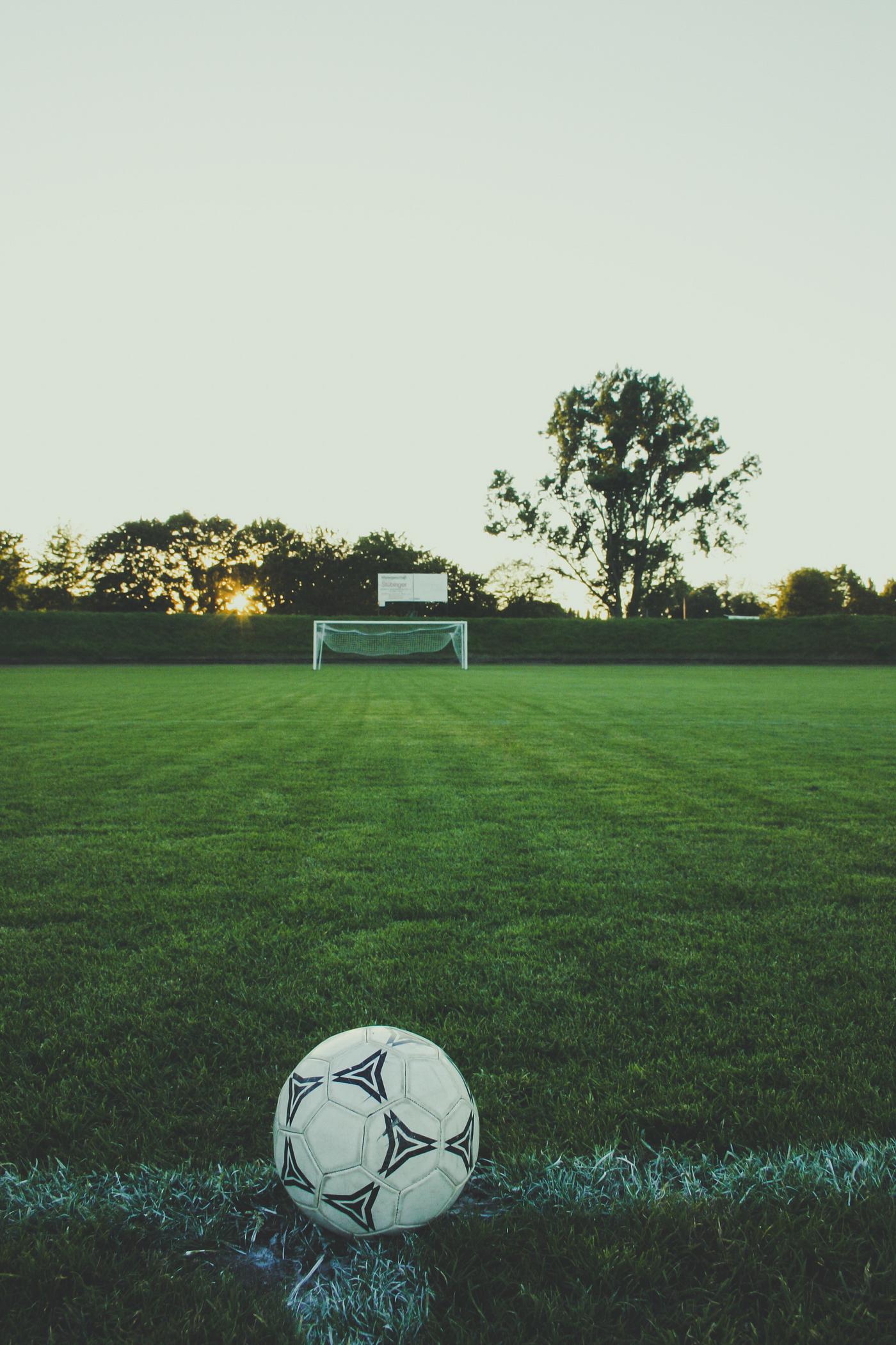 View of soccer field with a ball on the sideline View of soccer field with a ball on the sideline
