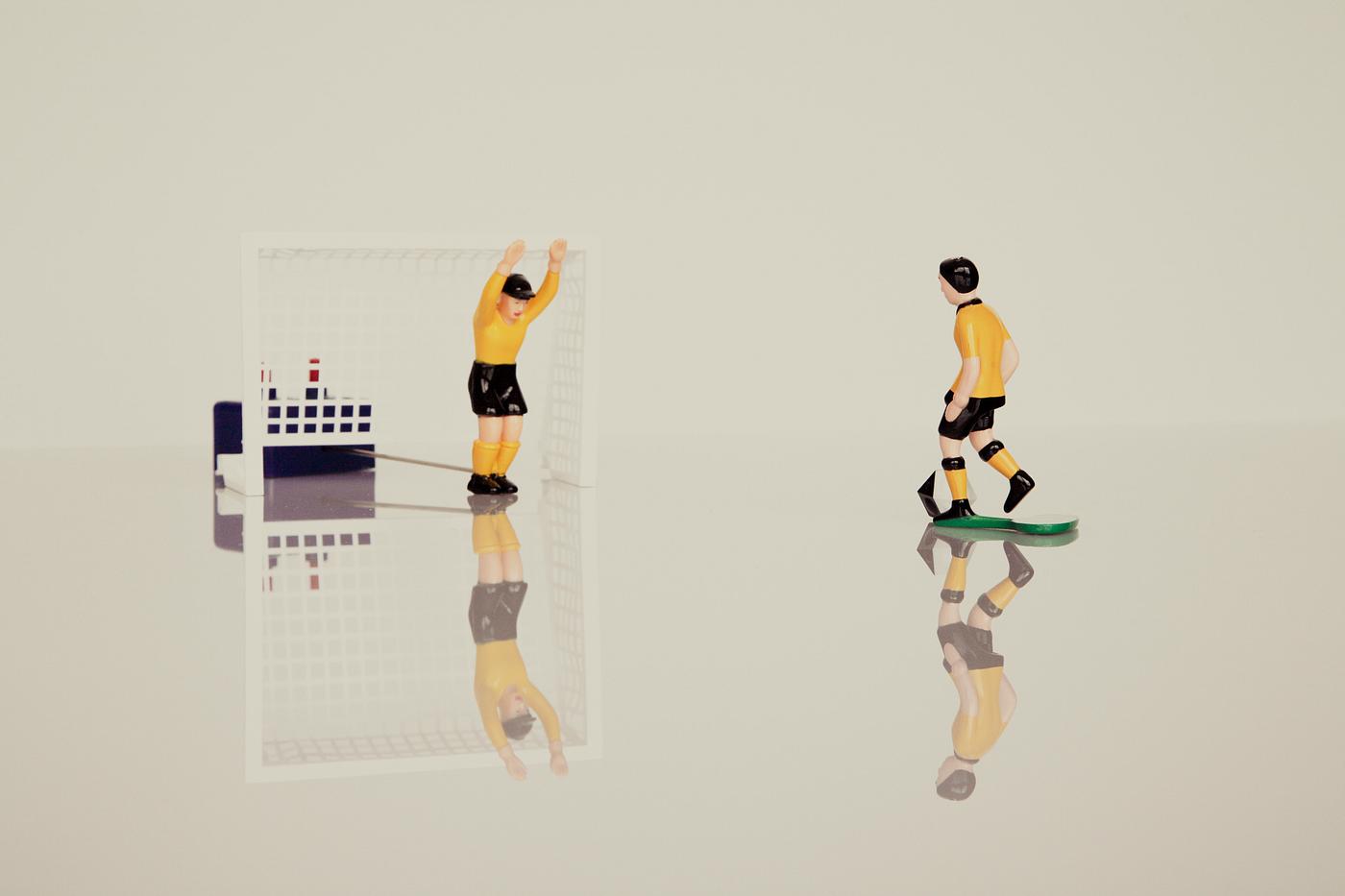 Soccer figurines on a marble table Soccer figurines on a marble table