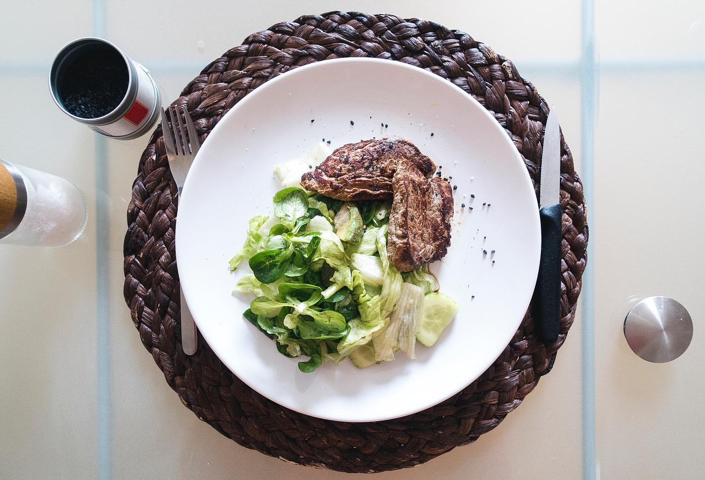 beef steak with green salad on table beef steak with green salad on table