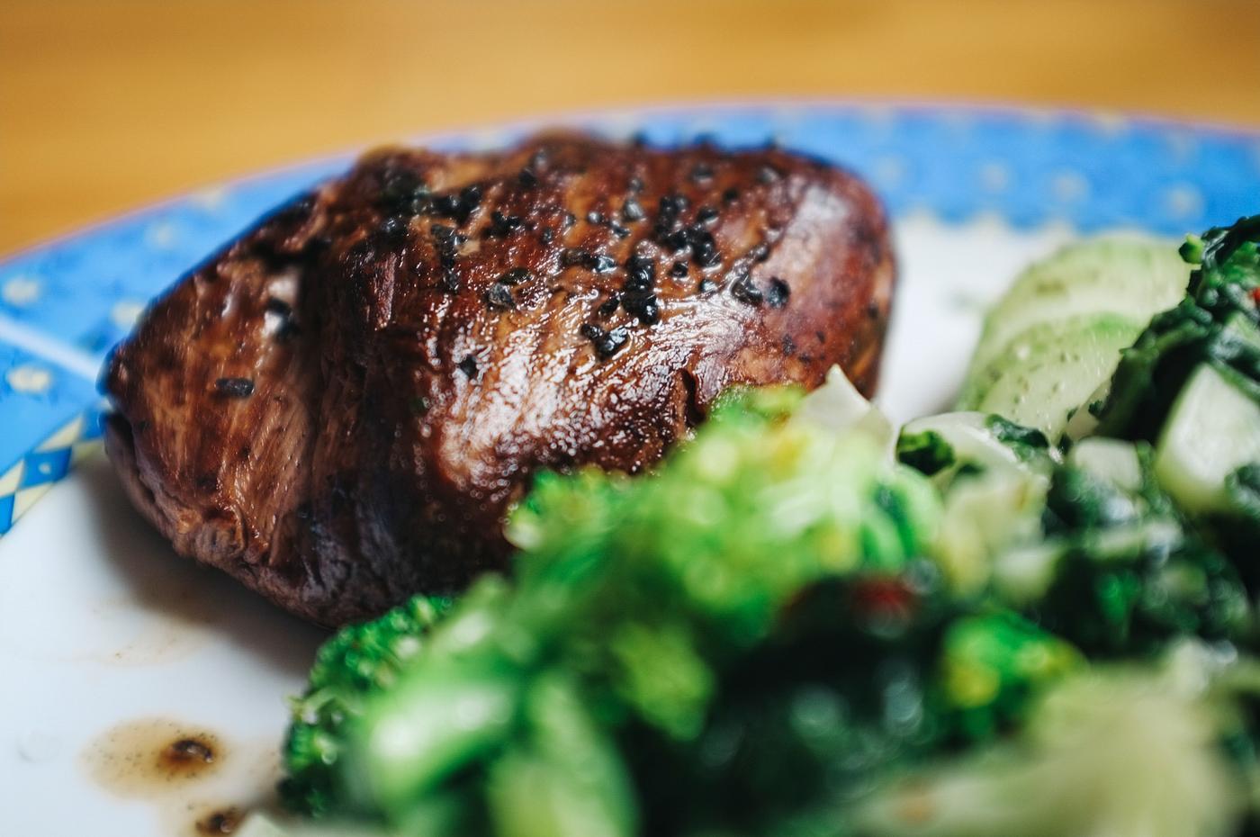 Beef steak sprinkled with black salt closeup Beef steak sprinkled with black salt closeup