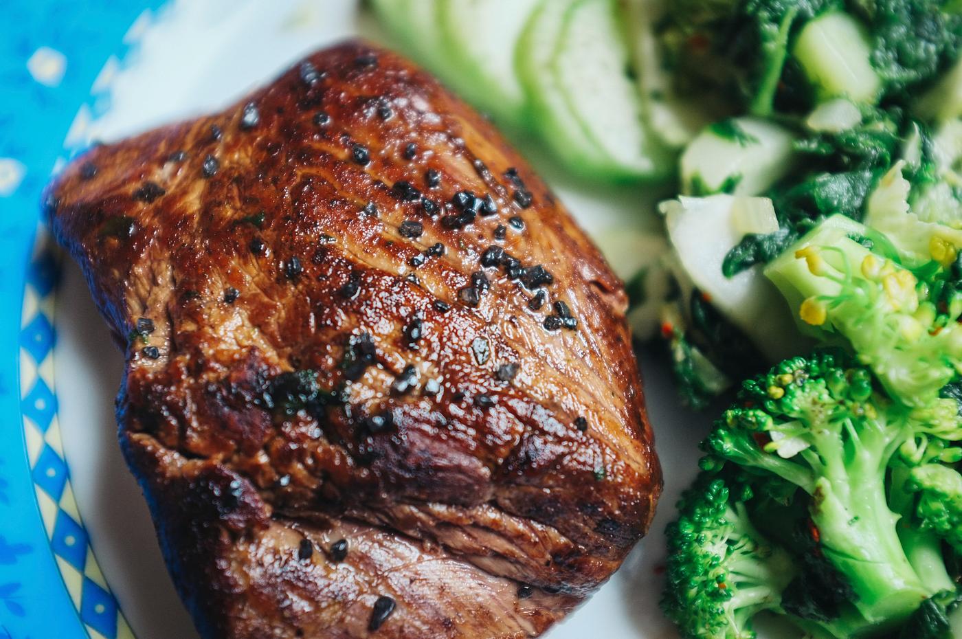 A beef steak with black salt closeup A beef steak with black salt closeup
