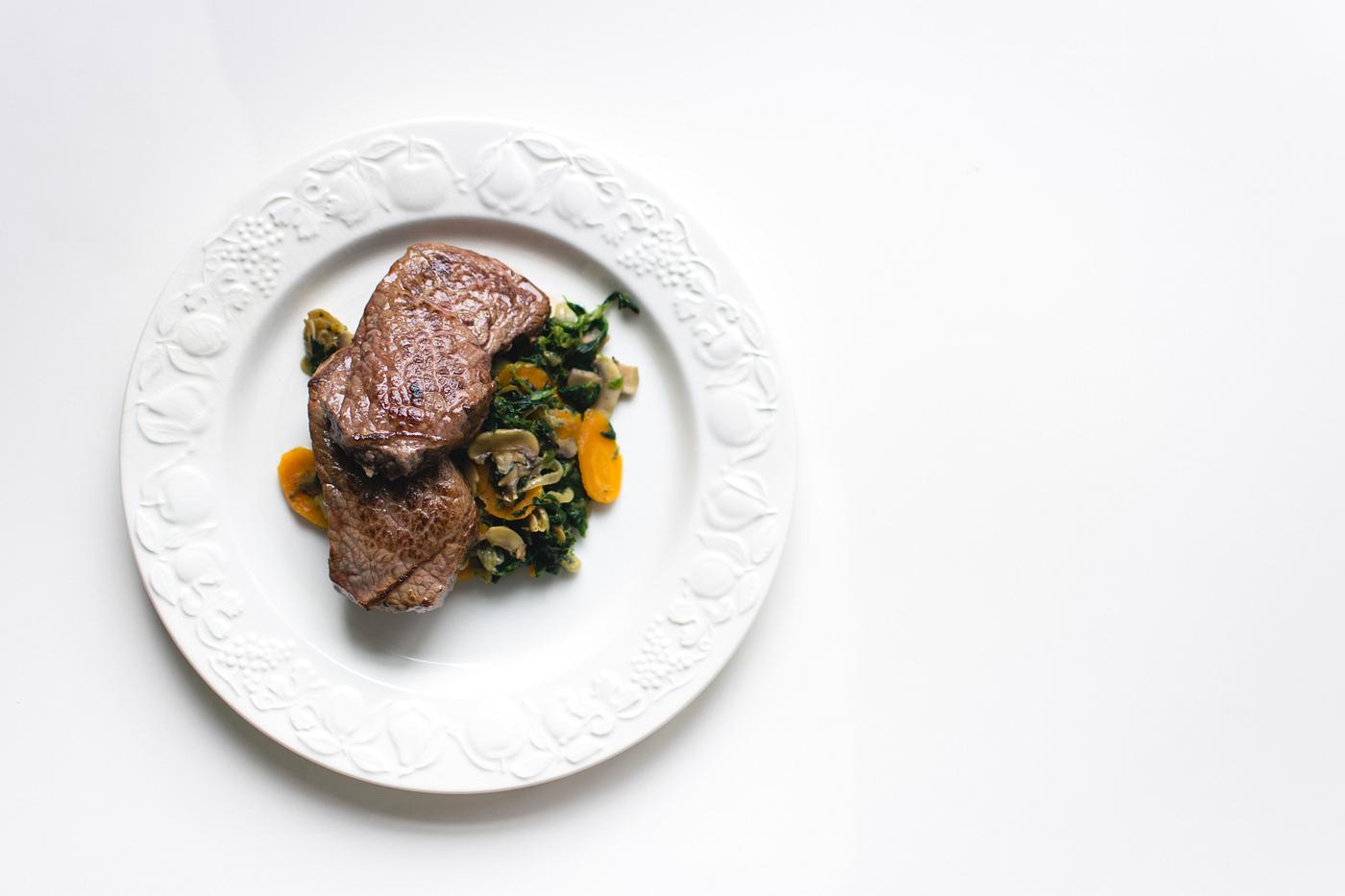 A beef steak and vegetables A beef steak and vegetables