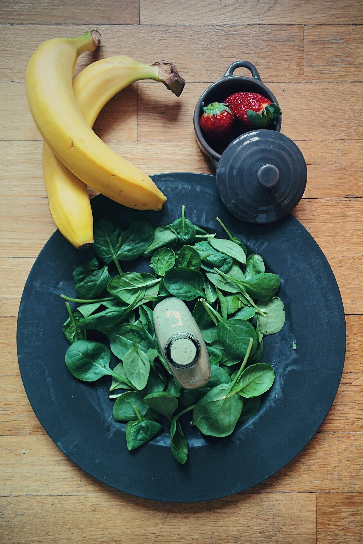 A bottle of green smoothie with fresh ingredients A bottle of green smoothie with fresh ingredients