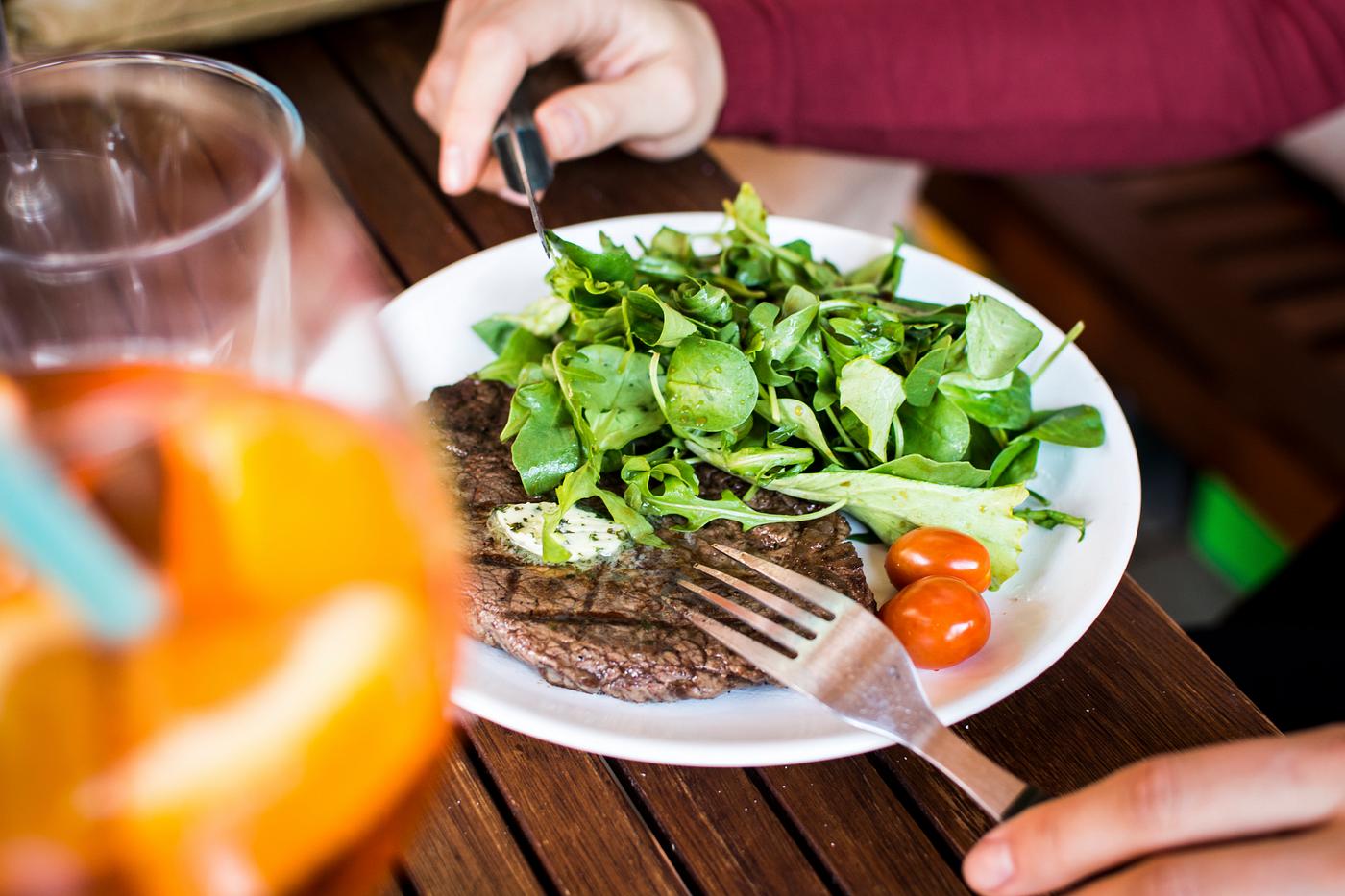 A barbequed steak with greens A barbequed steak with greens