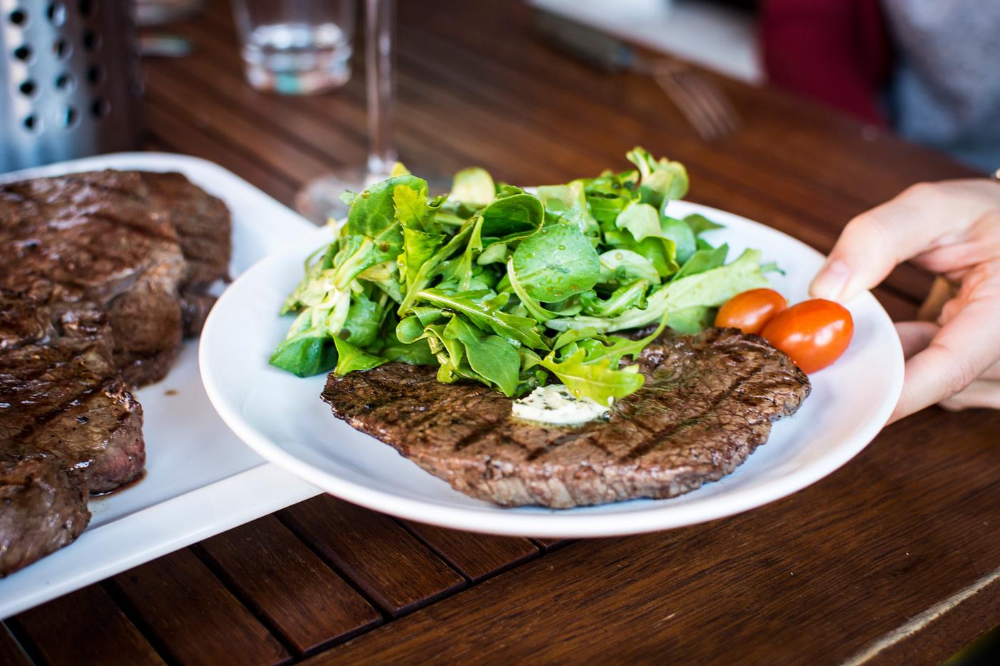 A barbeque steak with greens A barbeque steak with greens