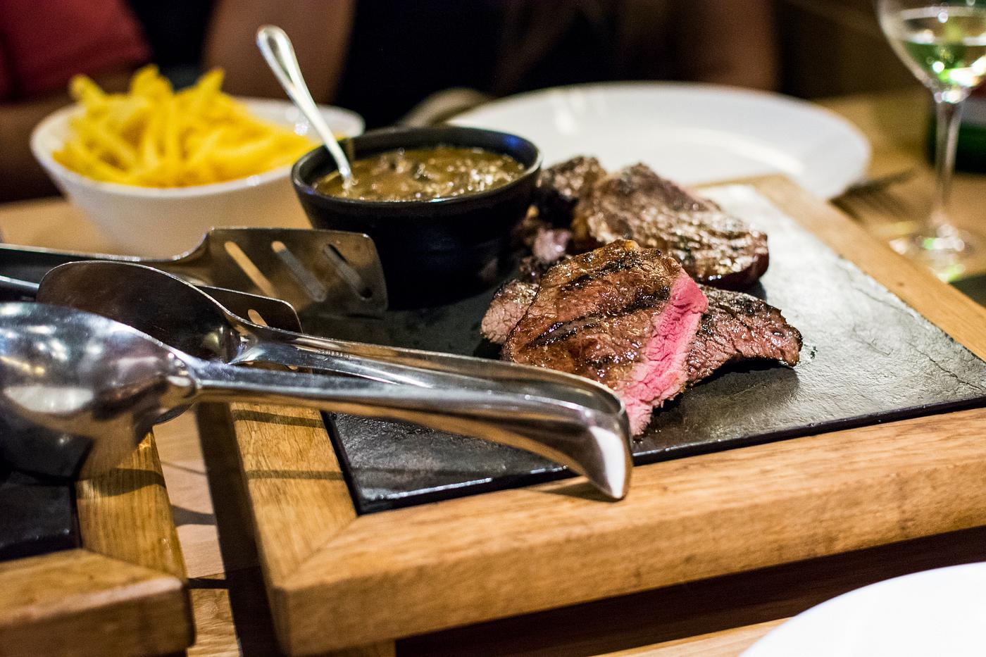 Juicy medium steak on a hot plate Juicy medium steak on a hot plate