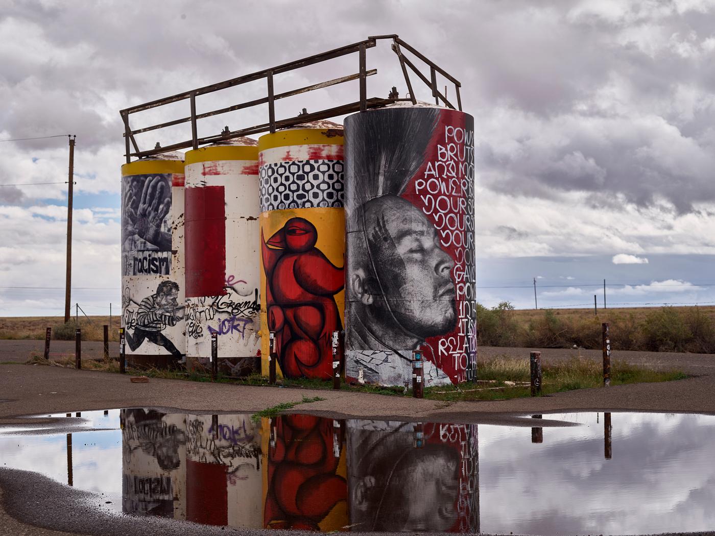 Artwork on water towers along a remote Arizona road leading to Monument Valley Navajo Tribal Park, a red-sand desert region... Artwork on water towers along a remote Arizona road leading to Monument Valley Navajo Tribal Park, a red-sand desert region...