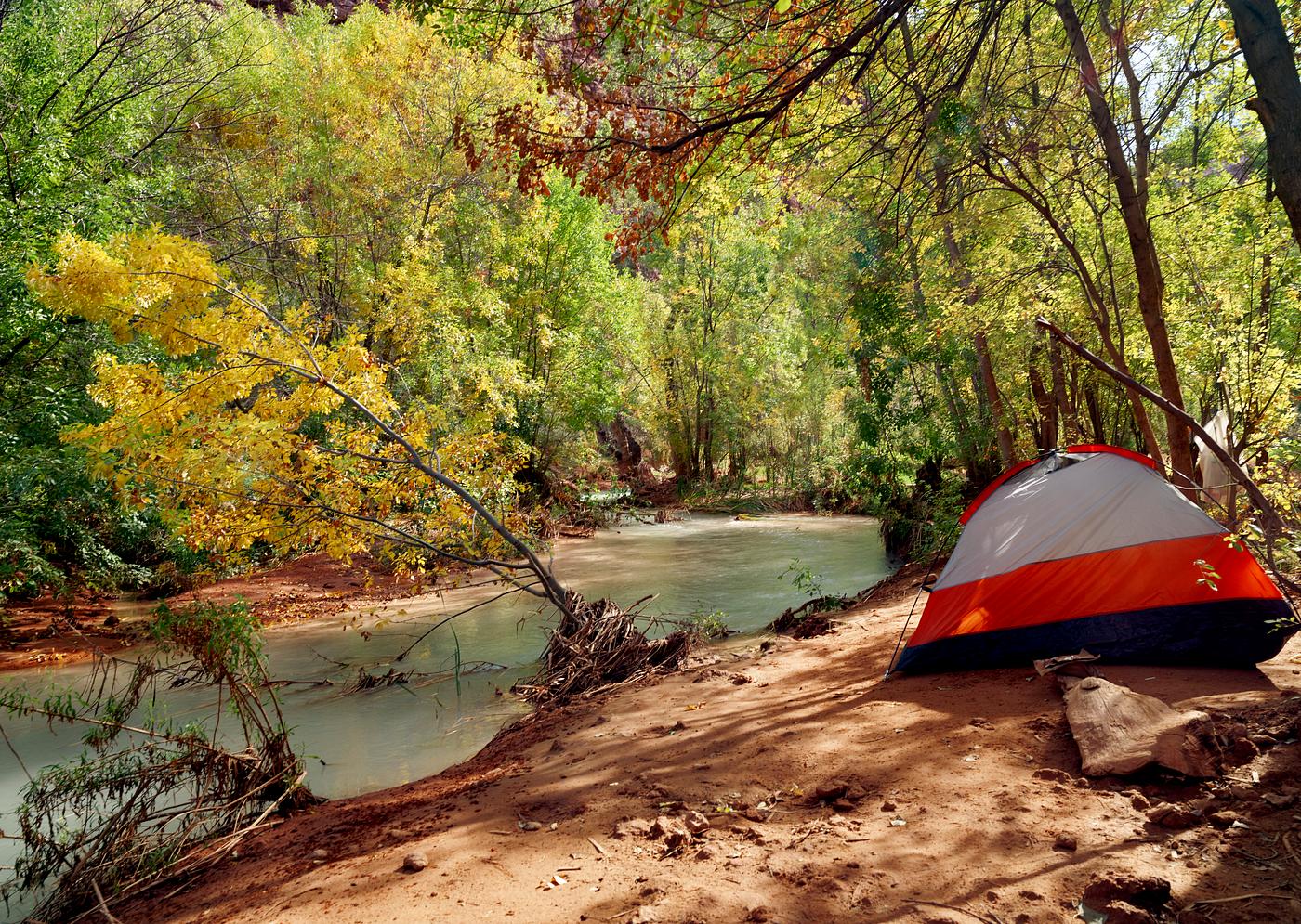 Havasu Creek flows past a campground between Mooney Falls and Havasu Falls — two of the five Havasupai waterfalls deep... Havasu Creek flows past a campground between Mooney Falls and Havasu Falls — two of the five Havasupai waterfalls deep...