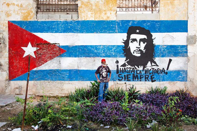 Havana mural on the wall Neighborhood in Old Havana with hand painted mural showing the Cuban flag and Che Guevara. Original image from Carol M.…