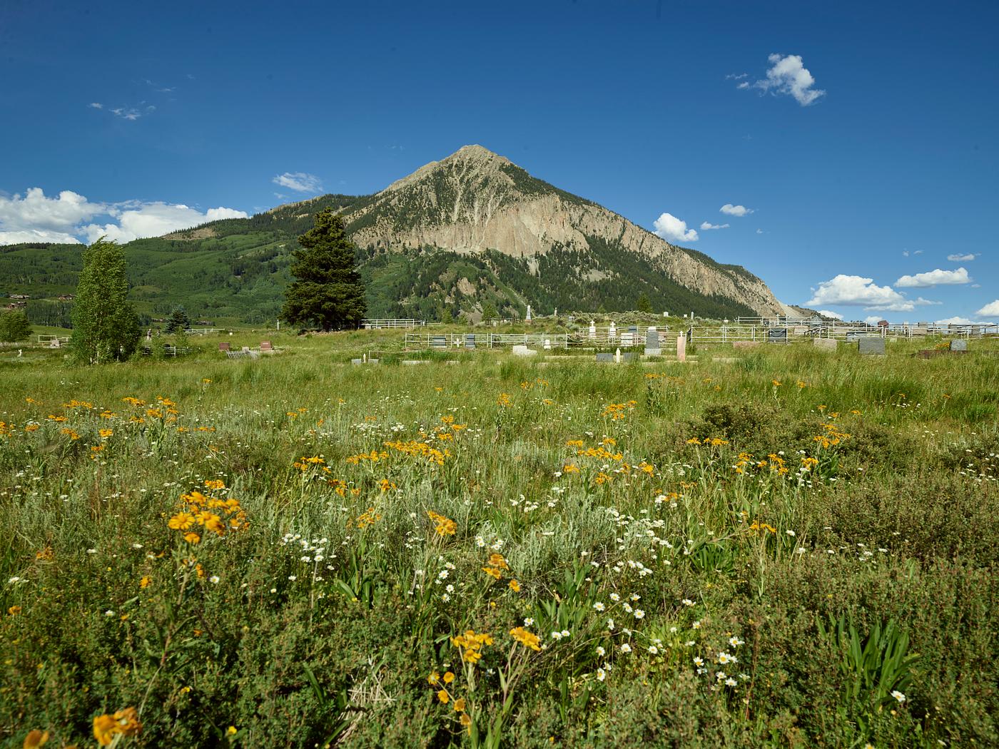Landscape, including many wildflowers for which the area is famous, around Crested Butte, Colorado. The formation that gives... Landscape, including many wildflowers for which the area is famous, around Crested Butte, Colorado. The formation that gives...