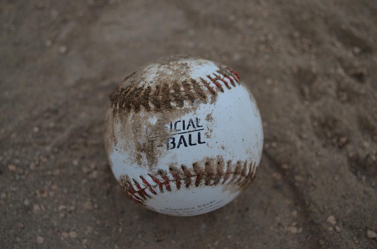 Closeup on baseball in sand. | Free Photo - rawpixel