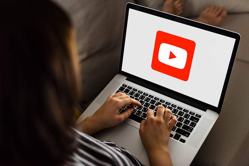 Woman using Youtube application on a laptop