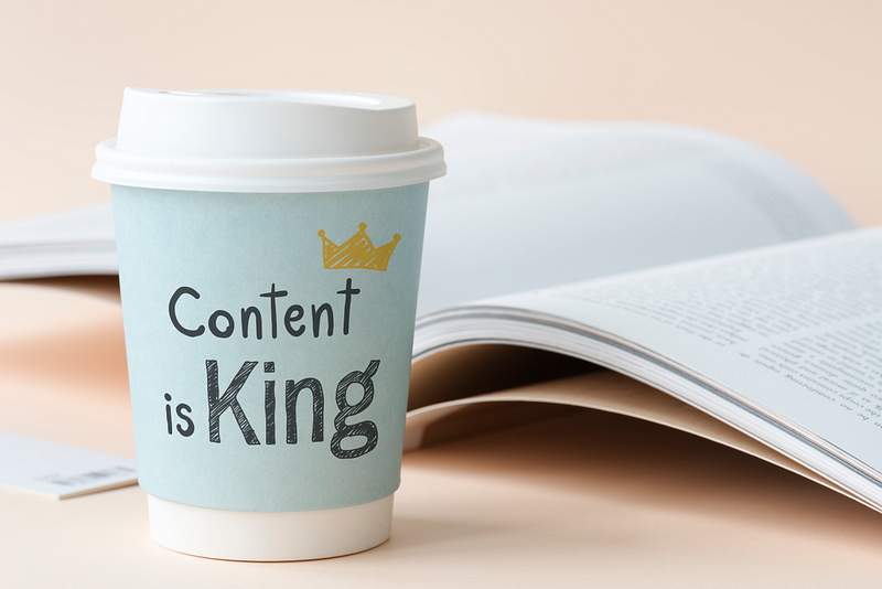 Content is king written on a paper cup 