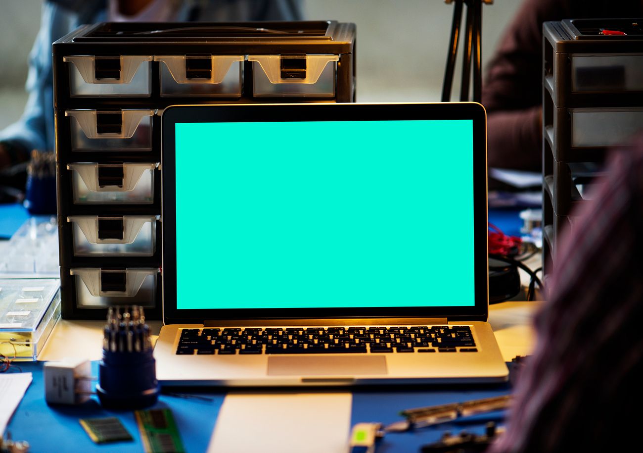 Download Laptop with mock-up screen on the table at electronics ...