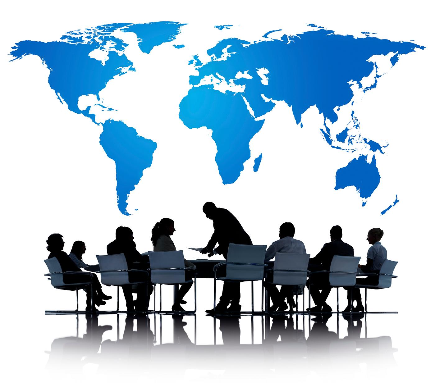 World map with silhouette of business people at a meeting table World map with silhouette of business people at a meeting table