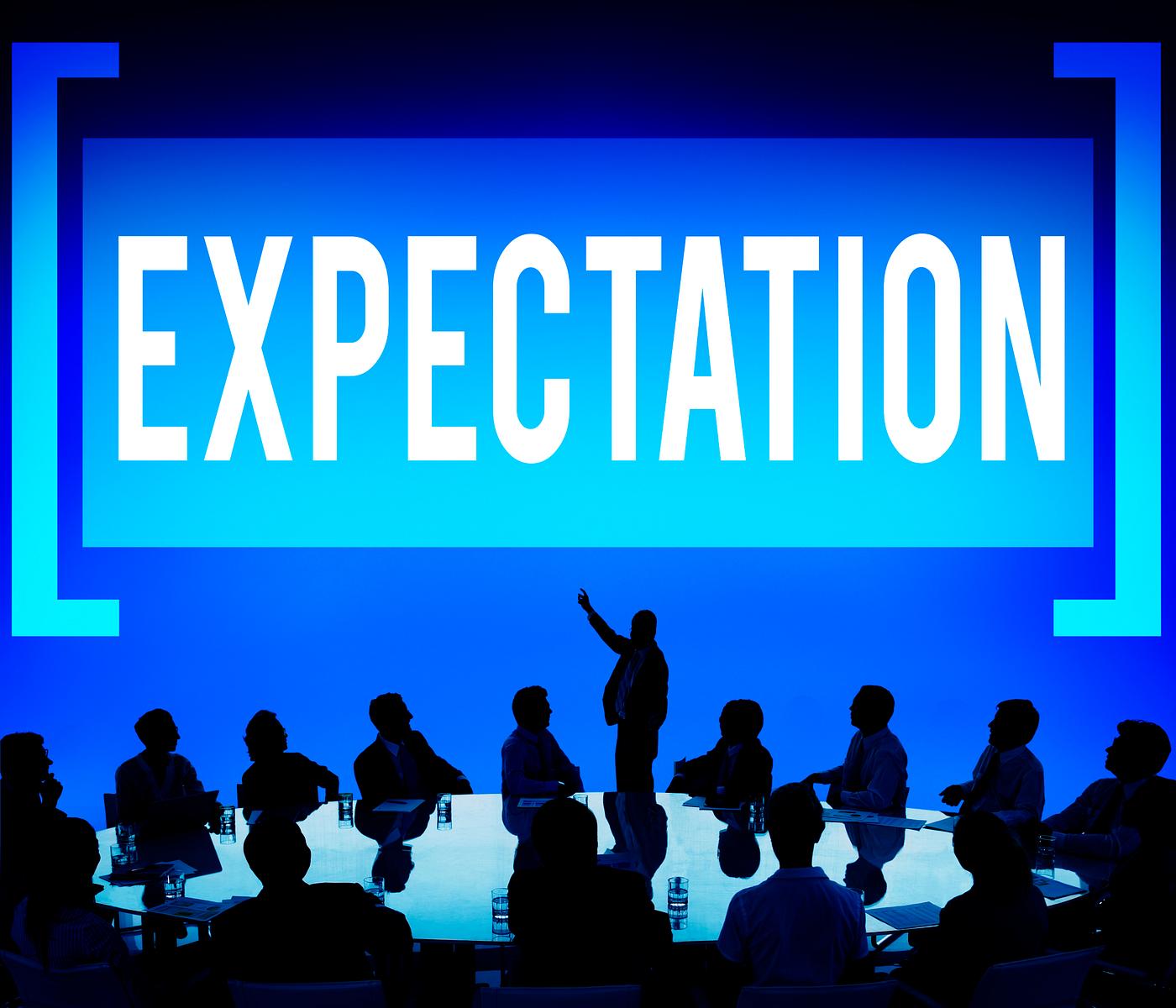 Expectation text with silhouette of business people at a meeting table Expectation text with silhouette of business people at a meeting table