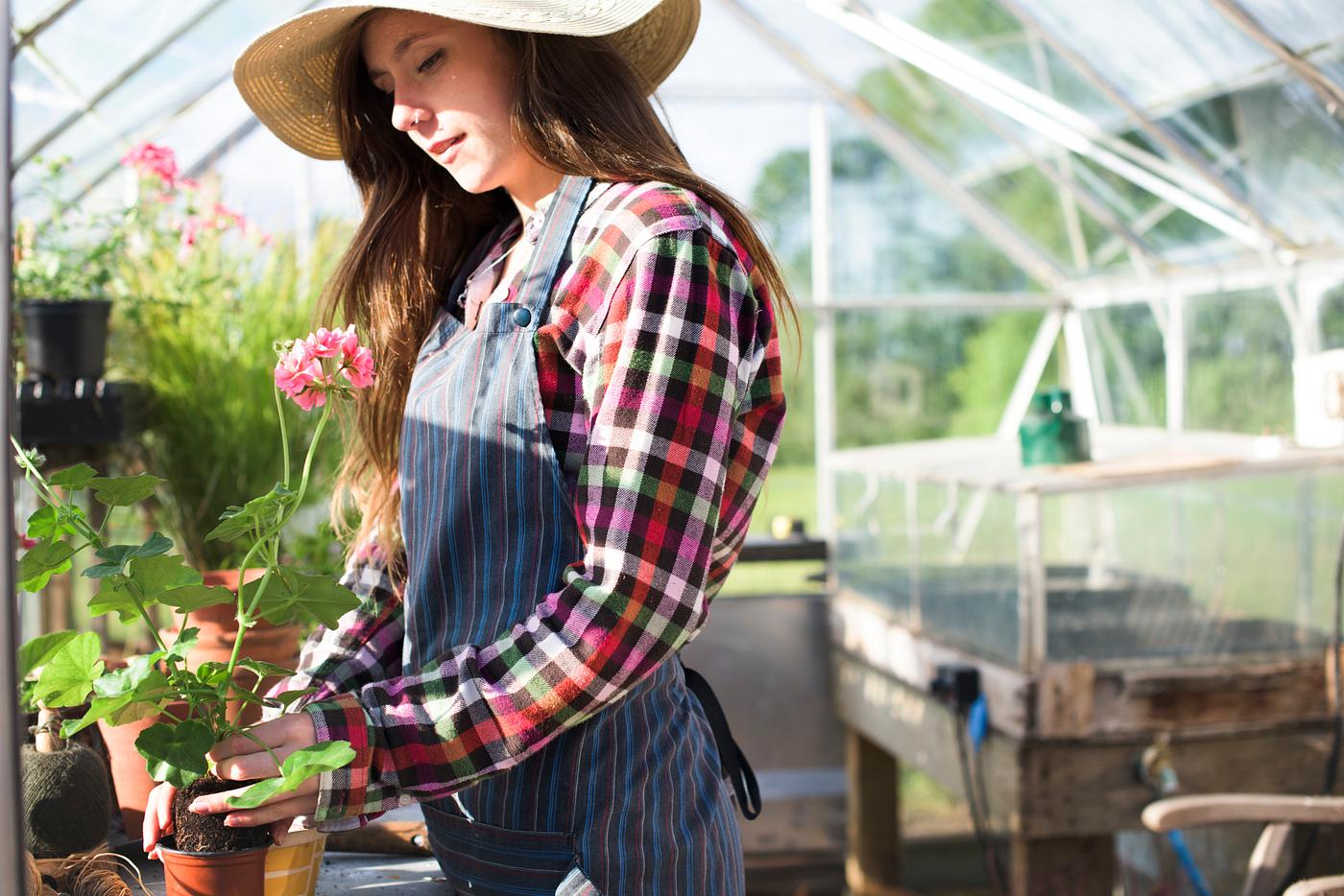 Young woman in the glass greenhouse Young woman in the glass greenhouse